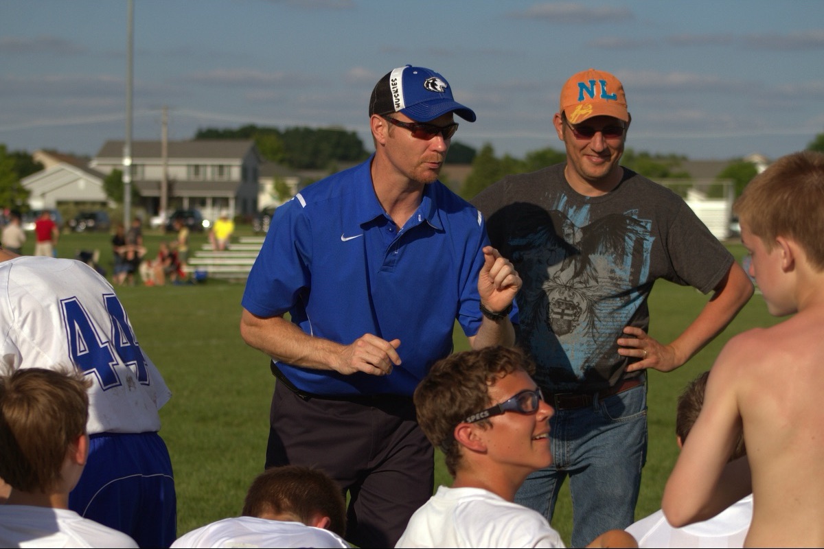 Shane coaching youth soccer from the sideline